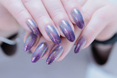 Female hands with long nails with french light blue lilac nail polishの写真素材