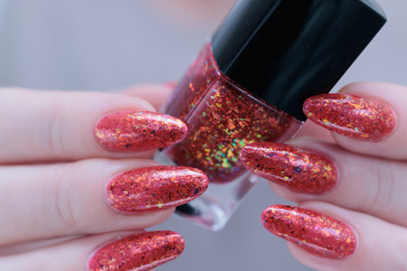Female hand with long nails and a bright red manicure