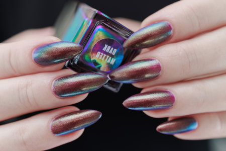 Beautiful woman's hand with long nails and multicolored nail polishの写真素材