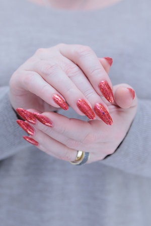 Woman hand with long nails and light orange coral neon manicureの写真素材