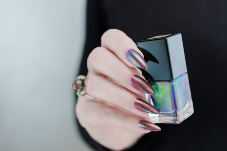 Beautiful woman's hand with long nails and multicolored nail polishの写真素材