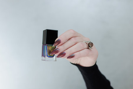 Beautiful woman's hand with long nails and multicolored nail polishの写真素材
