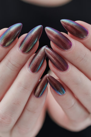 Beautiful woman's hand with long nails and multicolored nail polish