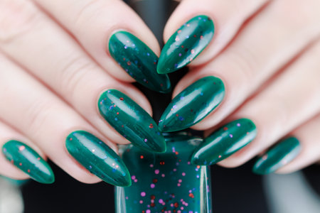 Woman's hand with long nails and emerald green nail polishの写真素材