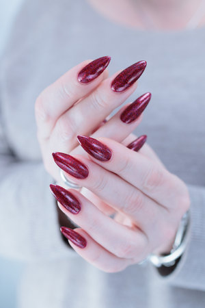 Female hand with long nails and a bright red manicure