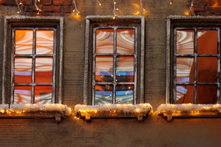 Background for design. New Year's decorations, toys and garlands on the windows in fabulous scenery....