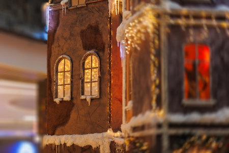 Background for design. New Year's decorations, toys and garlands on the windows in fabulous scenery. Houses for children in a public place.の写真素材