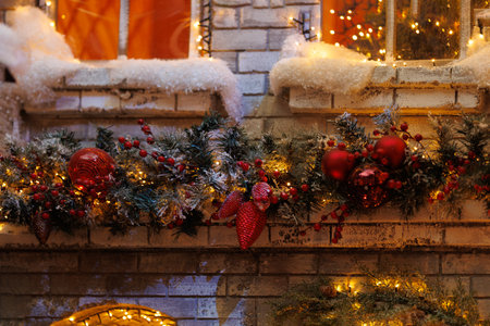Background for design. New Year's decorations, toys and garlands on the windows in fabulous scenery. Houses for children in a public place.の写真素材