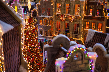 Background for design. New Year's decorations, toys and garlands on the windows in fabulous scenery. Houses for children in a public place.の写真素材