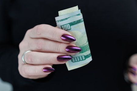 woman's hands holding American dollar paper bills