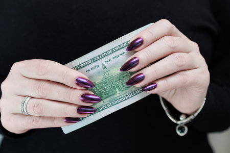 woman's hands holding American dollar paper bills
