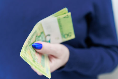 Female hands holding paper bills Belarusian rublesの写真素材