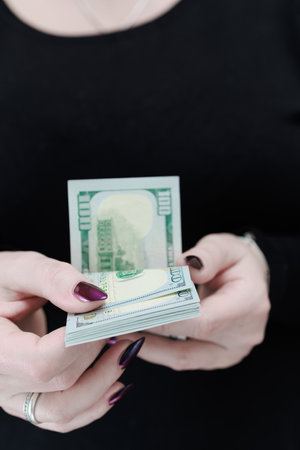woman's hands holding American dollar paper billsの写真素材