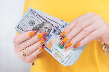 woman's hands holding American dollar paper billsの写真素材
