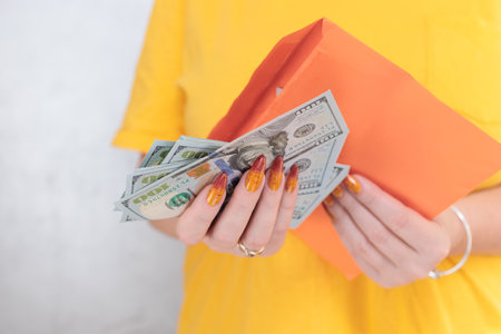 woman's hands holding American dollar paper billsの写真素材