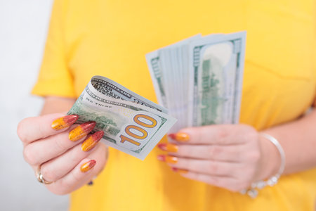 woman's hands holding American dollar paper billsの写真素材