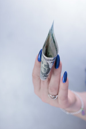woman's hands holding American dollar paper billsの写真素材