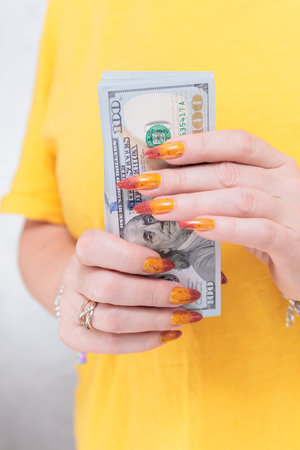 woman's hands holding American dollar paper billsの写真素材