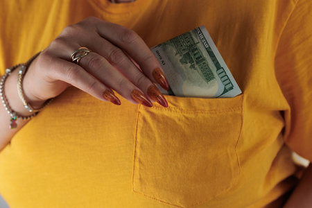 woman's hands holding American dollar paper bills