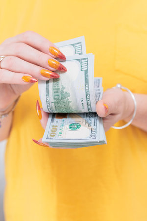 woman's hands holding American dollar paper billsの写真素材