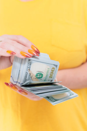 woman's hands holding American dollar paper billsの写真素材