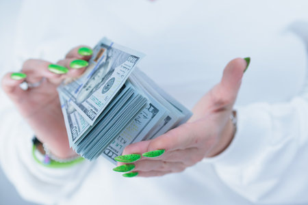 woman's hands holding American dollar paper billsの写真素材