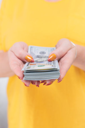 female hands holding American dollar paper bills