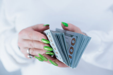 female hands holding American dollar paper bills