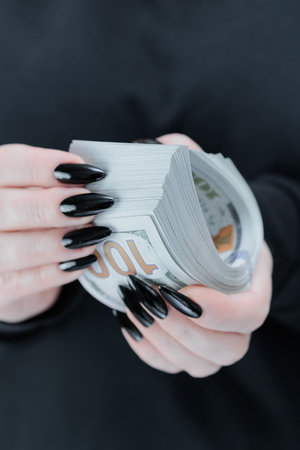 woman's hands holding American dollar paper billsの写真素材