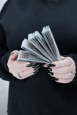 female hands holding American dollar paper bills