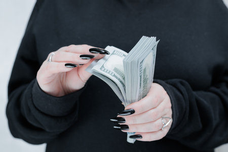 woman's hands holding American dollar paper billsの写真素材