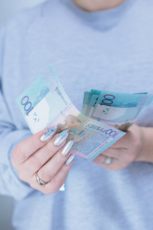 Female hands holding paper bills Belarusian rublesの写真素材