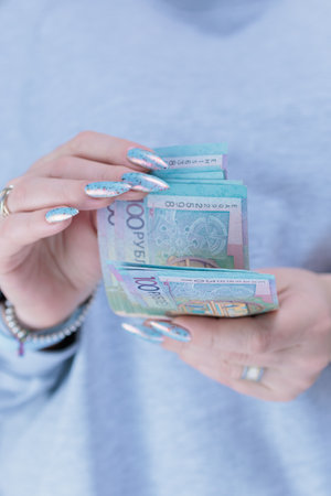 Female hands holding paper bills Belarusian rubles