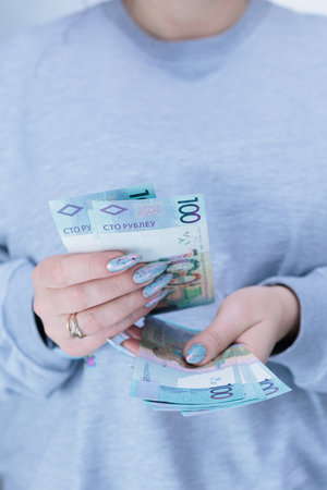 Female hands holding paper bills Belarusian rublesの写真素材