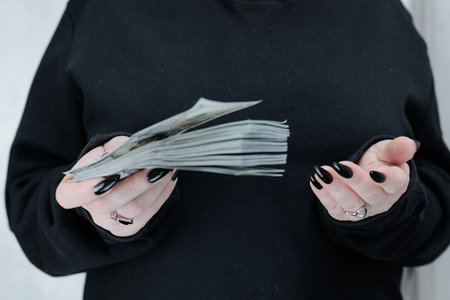 female hands holding American dollar paper bills