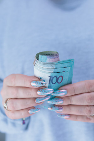 Female hands holding paper bills Belarusian rubles