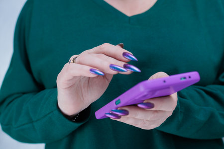 Woman's hands holding a large smartphoneの写真素材