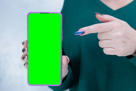Woman's hands holding a large smartphoneの写真素材