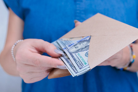 woman's hands holding American dollar paper billsの写真素材