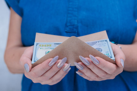 female hands holding American dollar paper bills