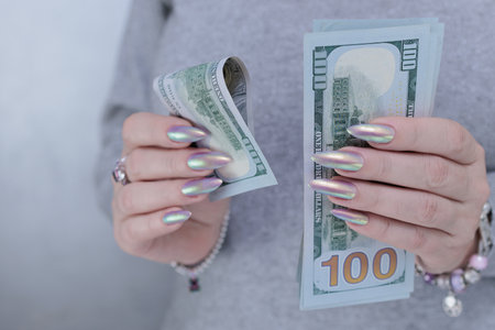 woman's hands holding American dollar paper billsの写真素材