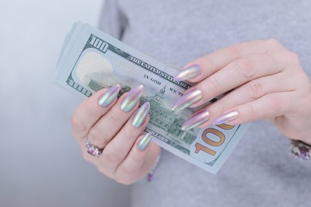 woman's hands holding American dollar paper billsの写真素材
