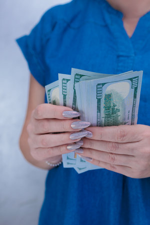 woman's hands holding American dollar paper billsの写真素材