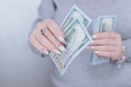 woman's hands holding American dollar paper billsの写真素材