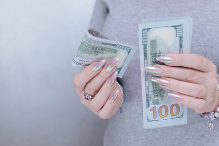 woman's hands holding American dollar paper billsの写真素材
