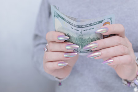 woman's hands holding American dollar paper billsの写真素材