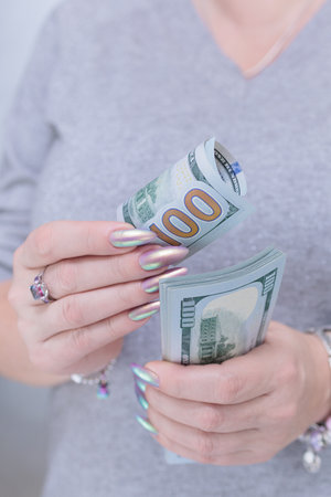 woman's hands holding American dollar paper billsの写真素材