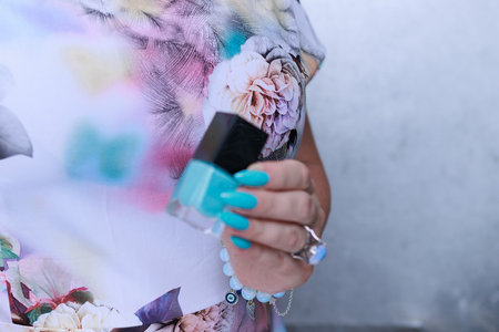 Female hand with long nails and light blue manicureの写真素材