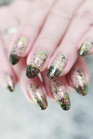 Woman's hands with long nails and white and black thermoの写真素材