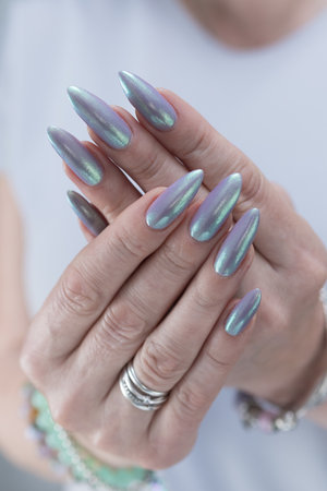 Hand with long nails and a lilac nude nail polishの写真素材
